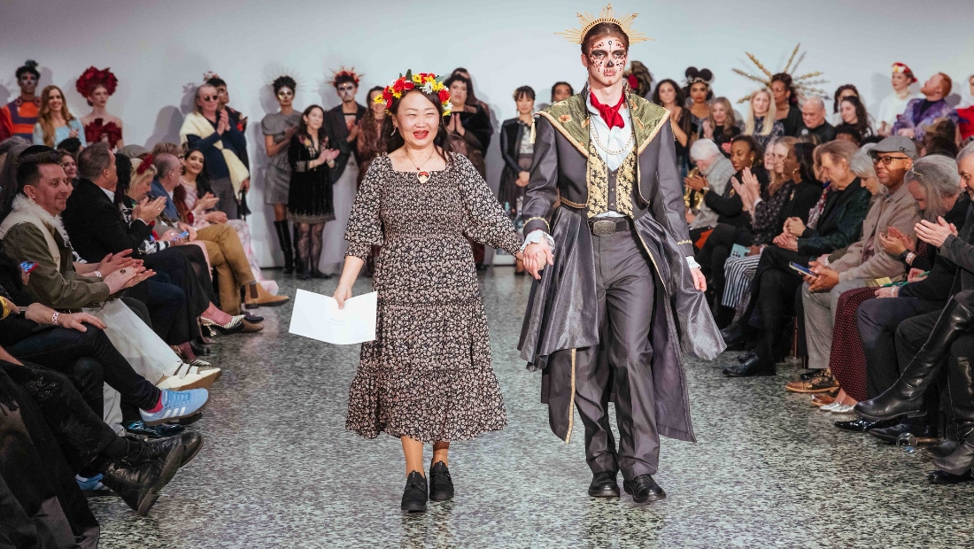 HCC Fashion Design alumna Kim Lai walks with her model wearing her winning design “Appearances” in the Reengineer: Repurpose the Forgotten category.