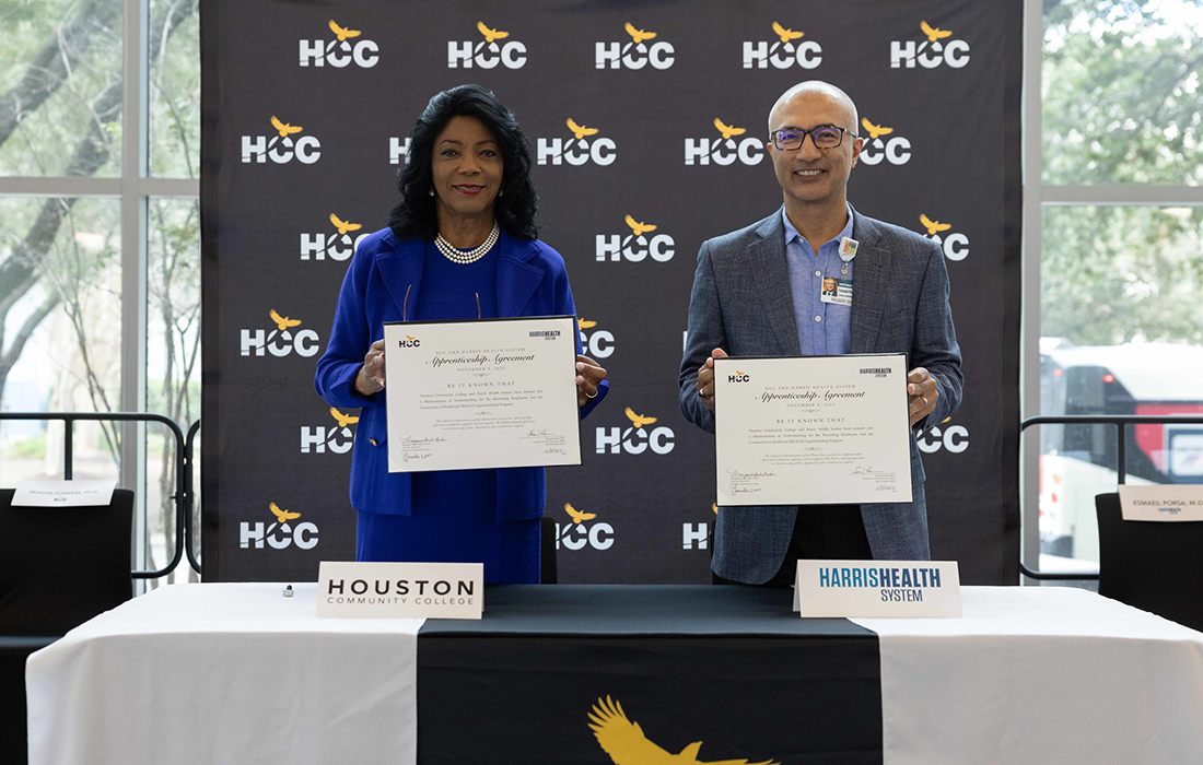 Margaret Ford Fisher, Ed.D., and Esmaeil Porsa, M.D., hold up the memorandum of understanding between Houston Community College and Harris Health System.
