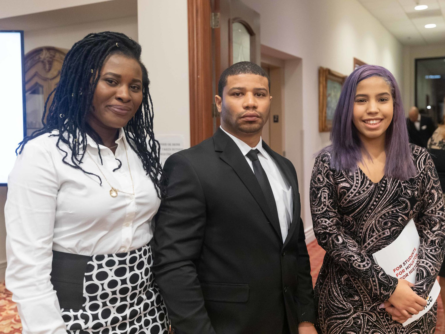 Three African American student recipients of scholarships.
